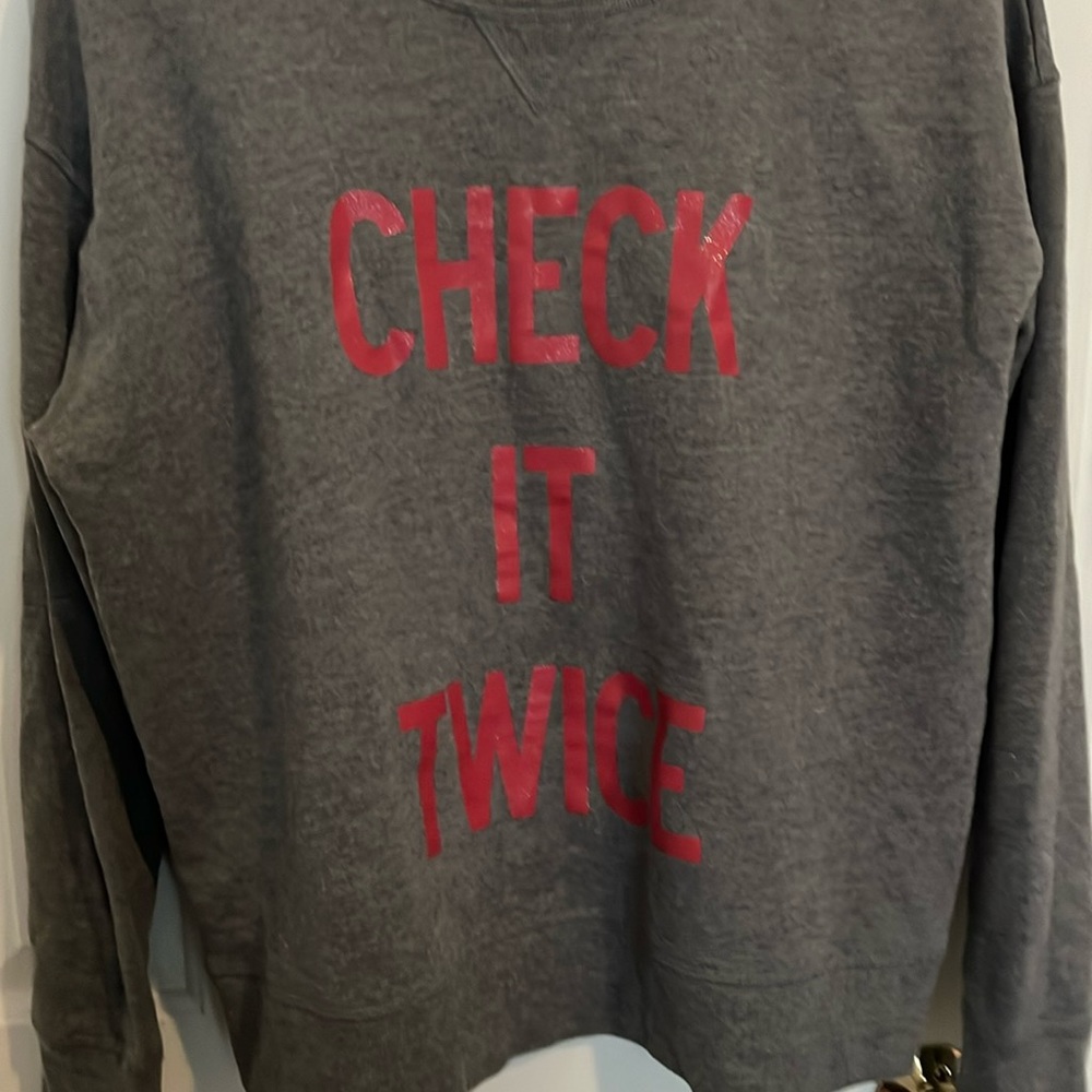 Victoria’s Secret sweatshirt size large says check it twice